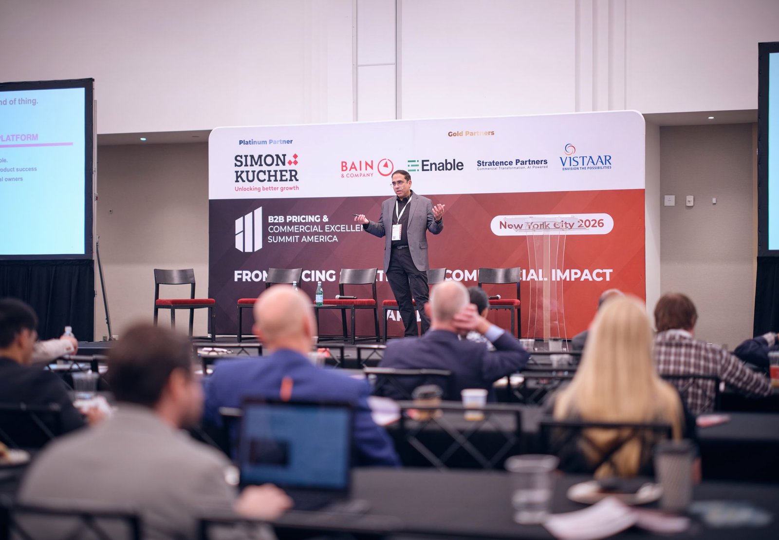 Puneet Srivastava speaking on stage to a full room at the B2B Pricing & Commercial Excellence Summit America in New York